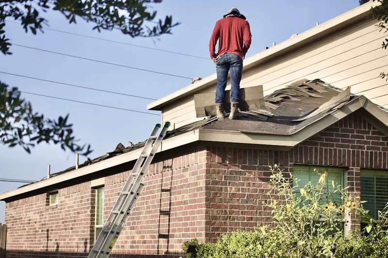Professional roofer working on a residential roof in Bay Lake